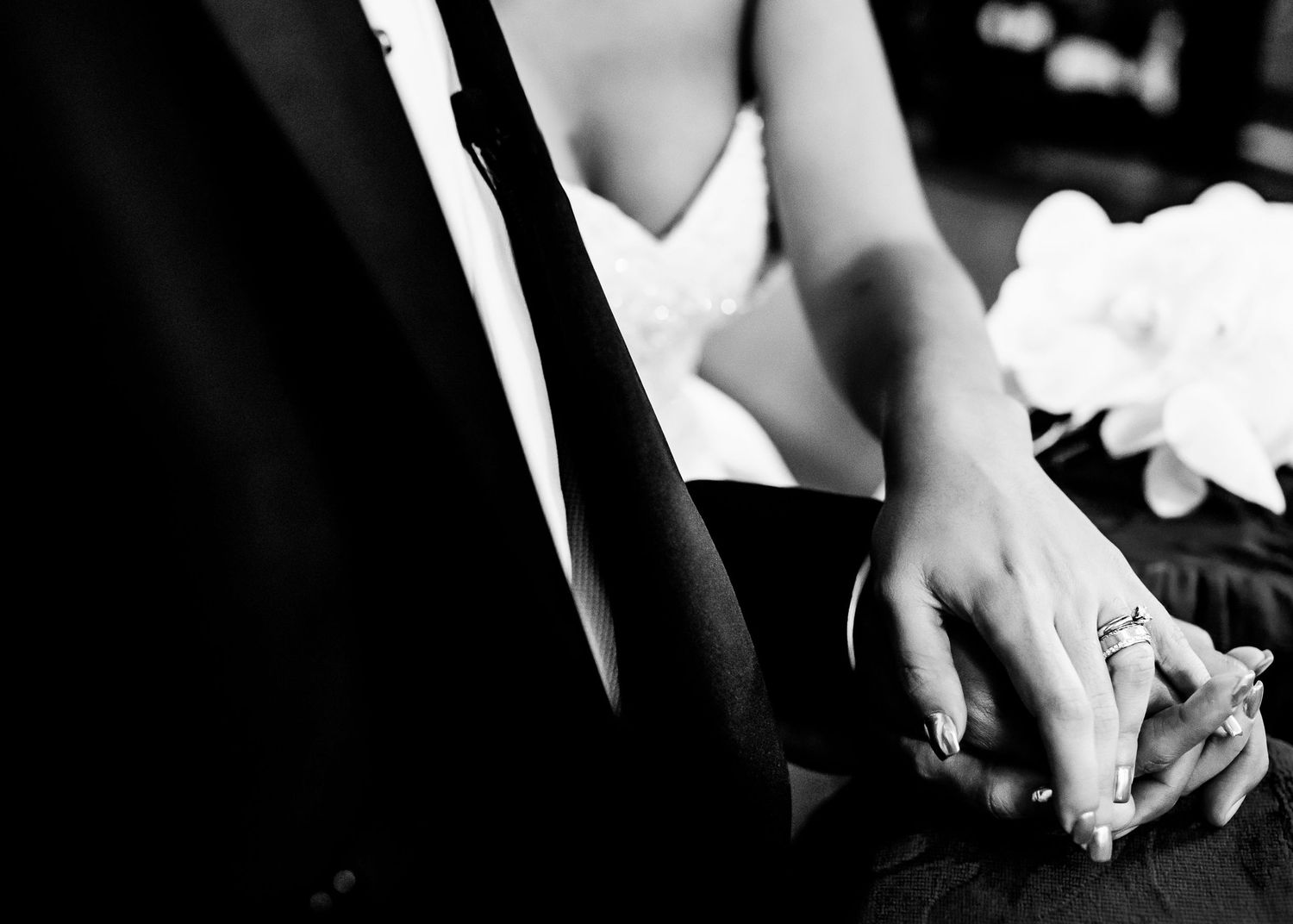 Close-up detail of hands holding during an emotional wedding ceremony moment.