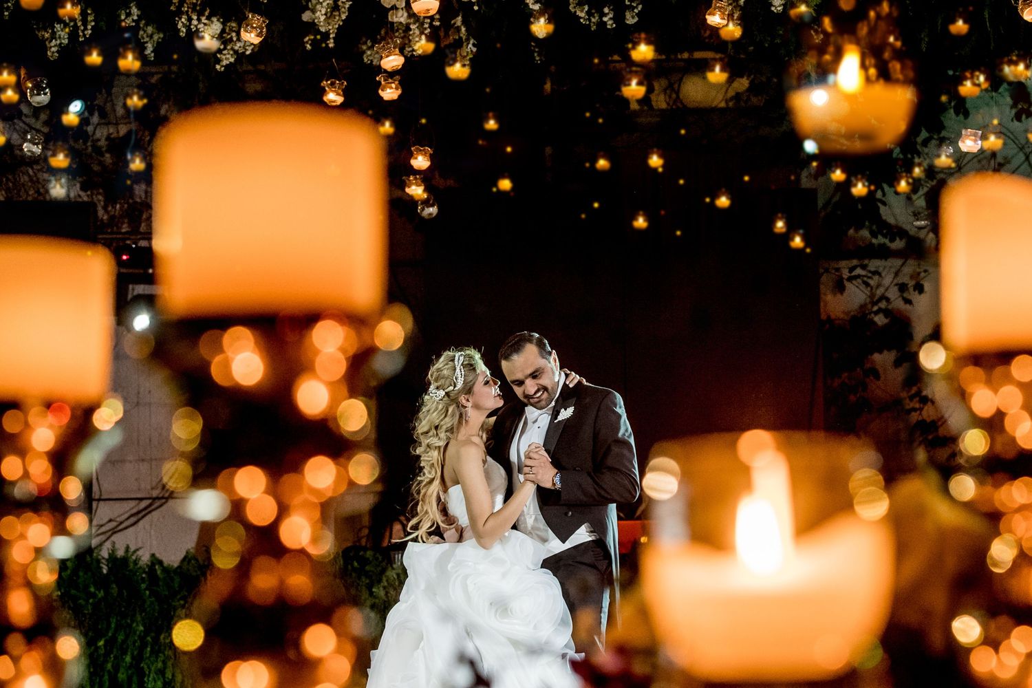 Wedding celebration with glowing lanterns and warm ambient lighting creating a romantic atmosphere.