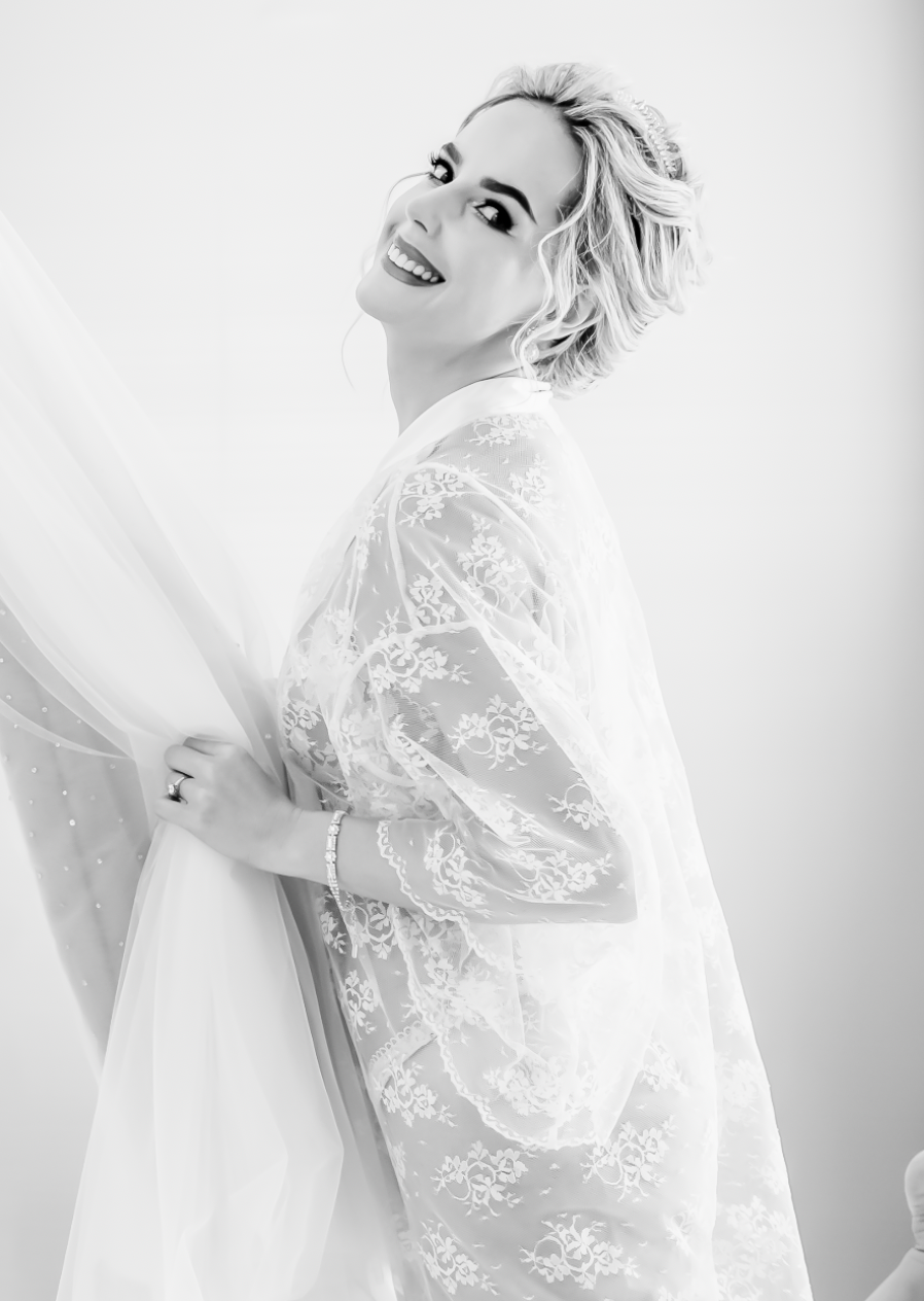 Ethereal bridal portrait in white lace with soft natural lighting.