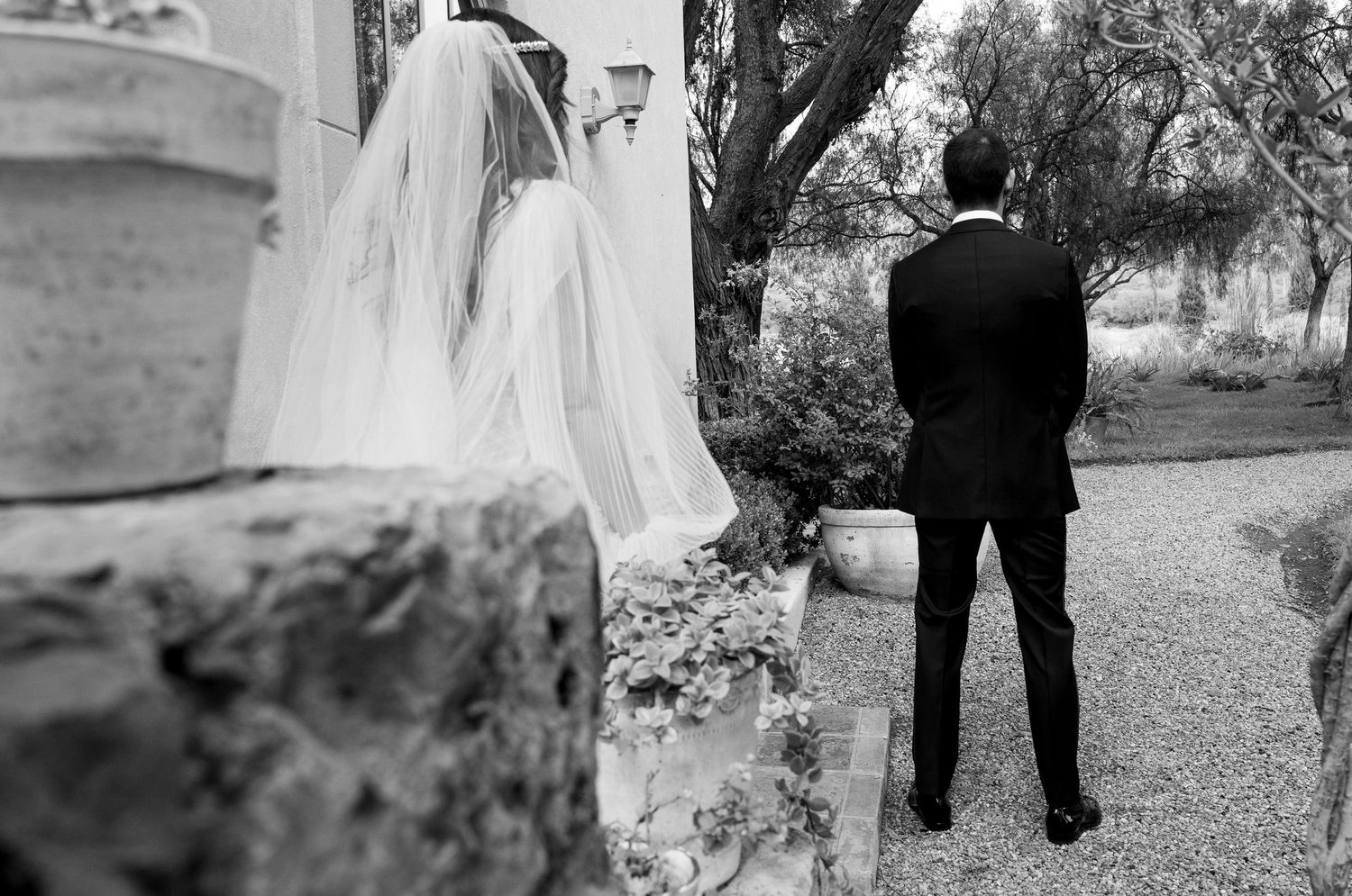 A black and white wedding photography collage showing romantic moments between couples in outdoor garden settings.