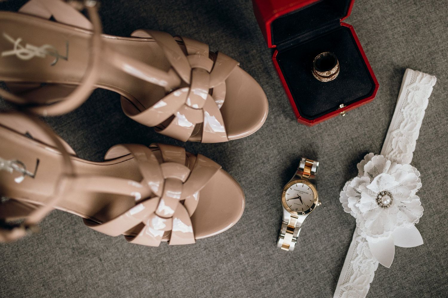 Elegant nude leather sandals arranged in a stylish wedding day flatlay composition.