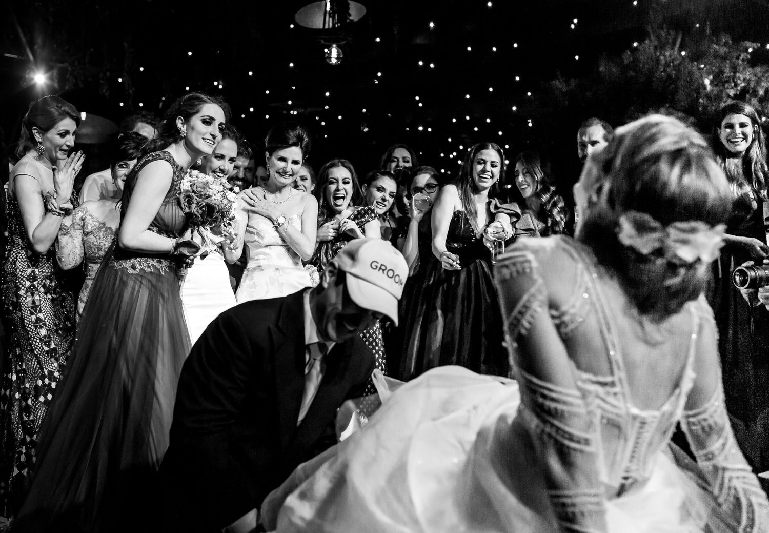 Wedding reception dance floor with sparkling lights and celebrating guests.