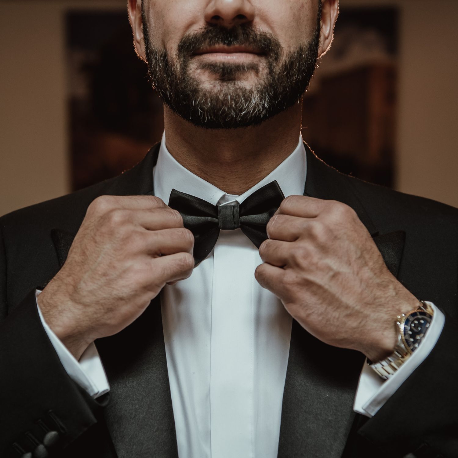 Close-up shots of a black tuxedo bow tie being adjusted.