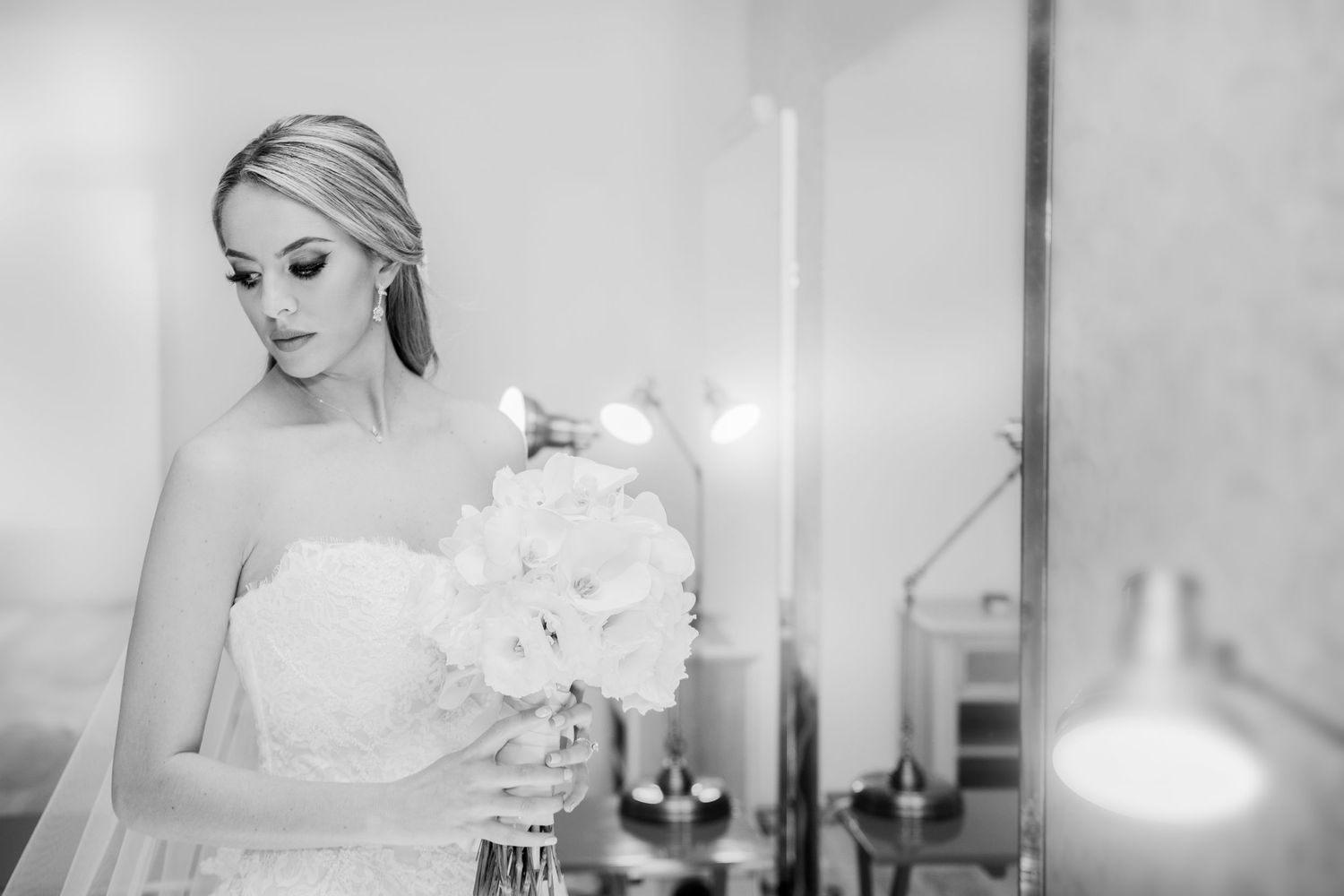 Elegant bridal portraits in soft lighting showcasing wedding day preparation moments.