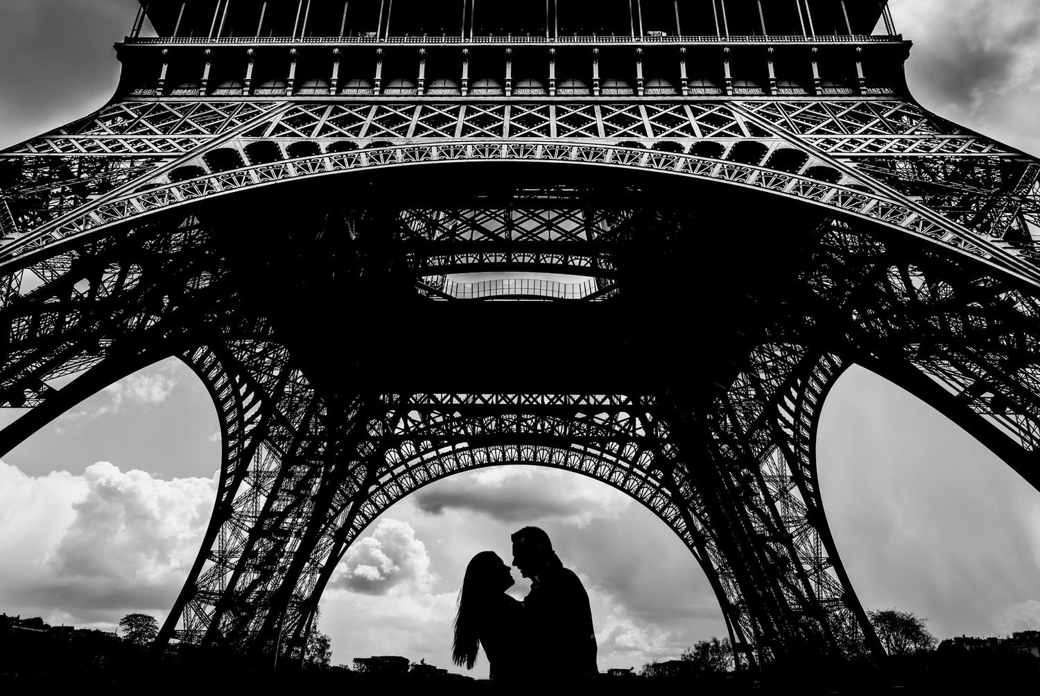 Dramatic black and white architectural shots of the Eiffel Tower from different dramatic angles.