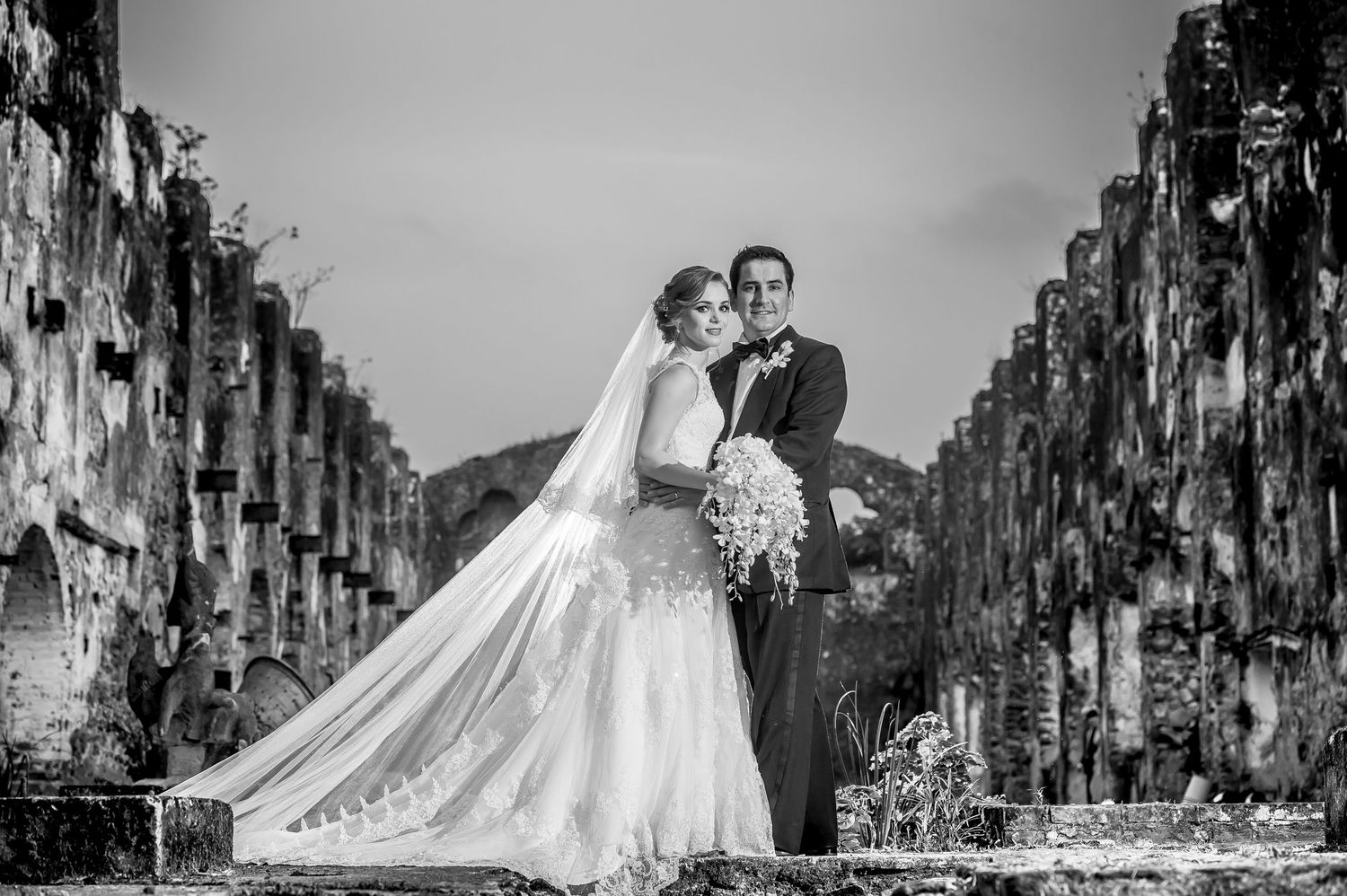 Wedding portraits taken against dramatic mountain cliffs and natural landscape.