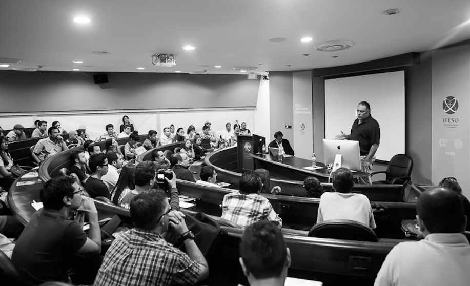 Audience members seated in rows at a professional photography conference or workshop presentation.