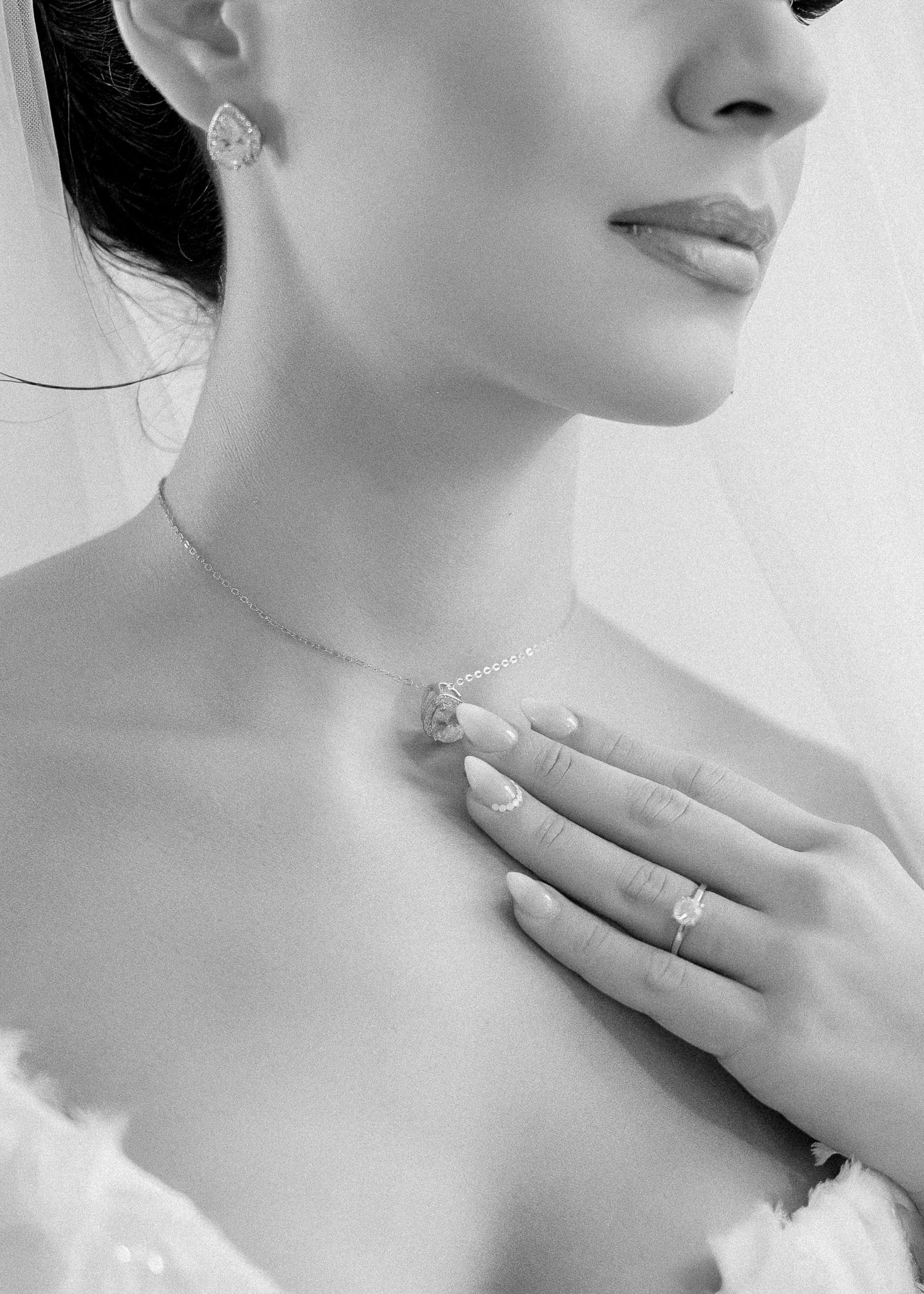 Artistic black and white close-ups showing wedding day jewelry and hands.