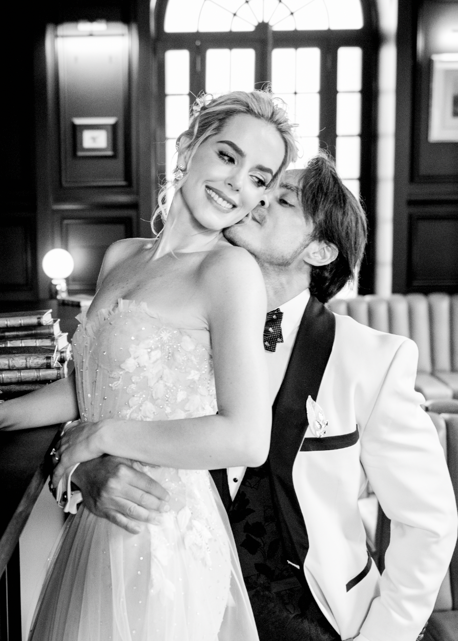 Black and white wedding portrait in an elegant vintage interior.