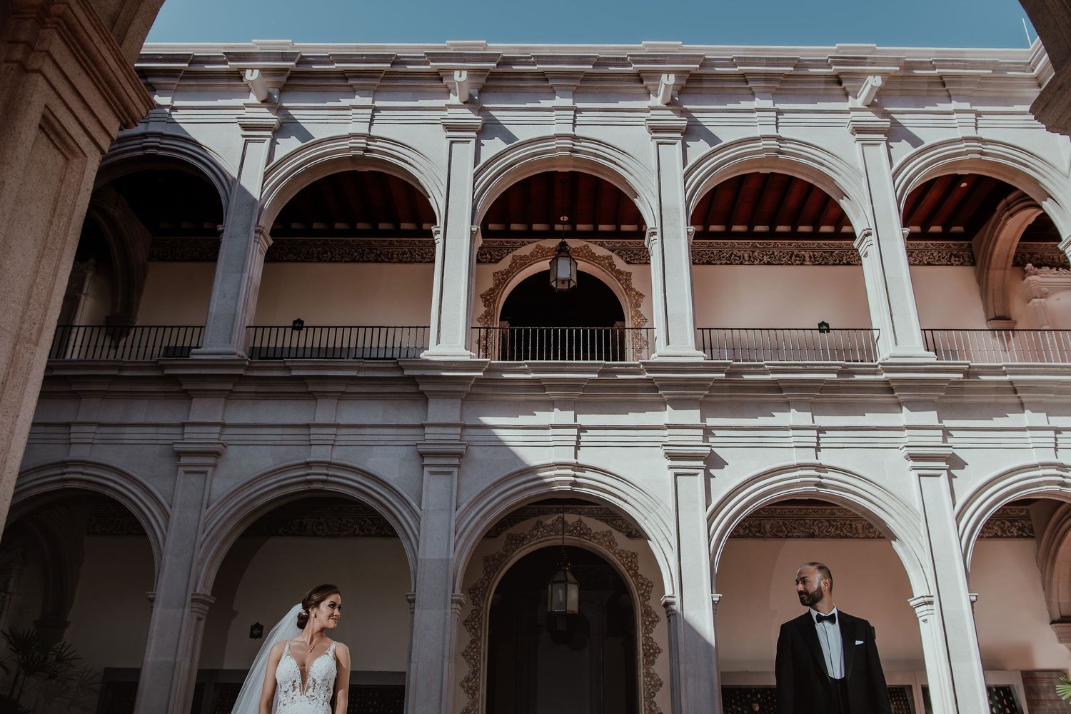 Classical architecture with arched colonnade at historic wedding venue.