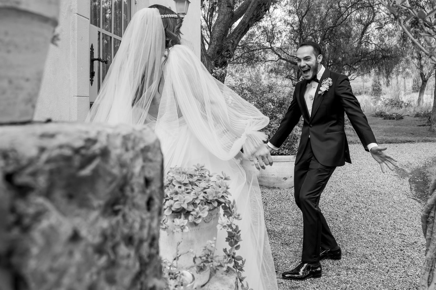 Black and white wedding photos showing romantic moments between newlyweds in an outdoor garden setting.