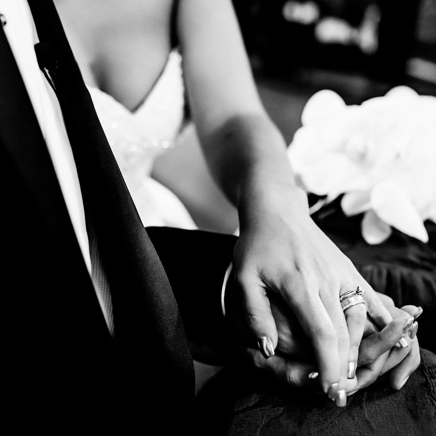 Close-up of hands holding during an intimate wedding ceremony moment.