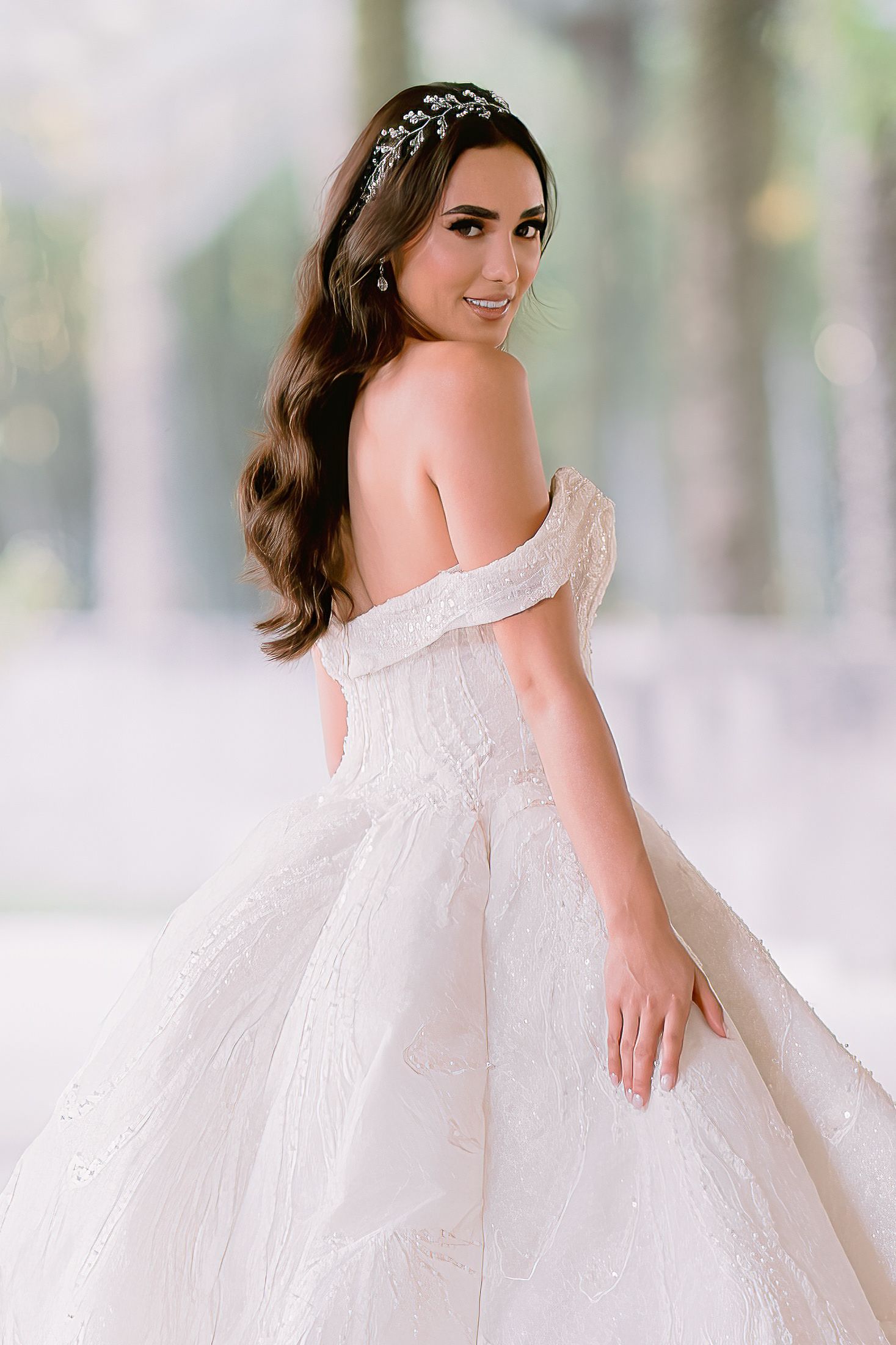Princess style wedding gown with delicate off-shoulder design in pure white.