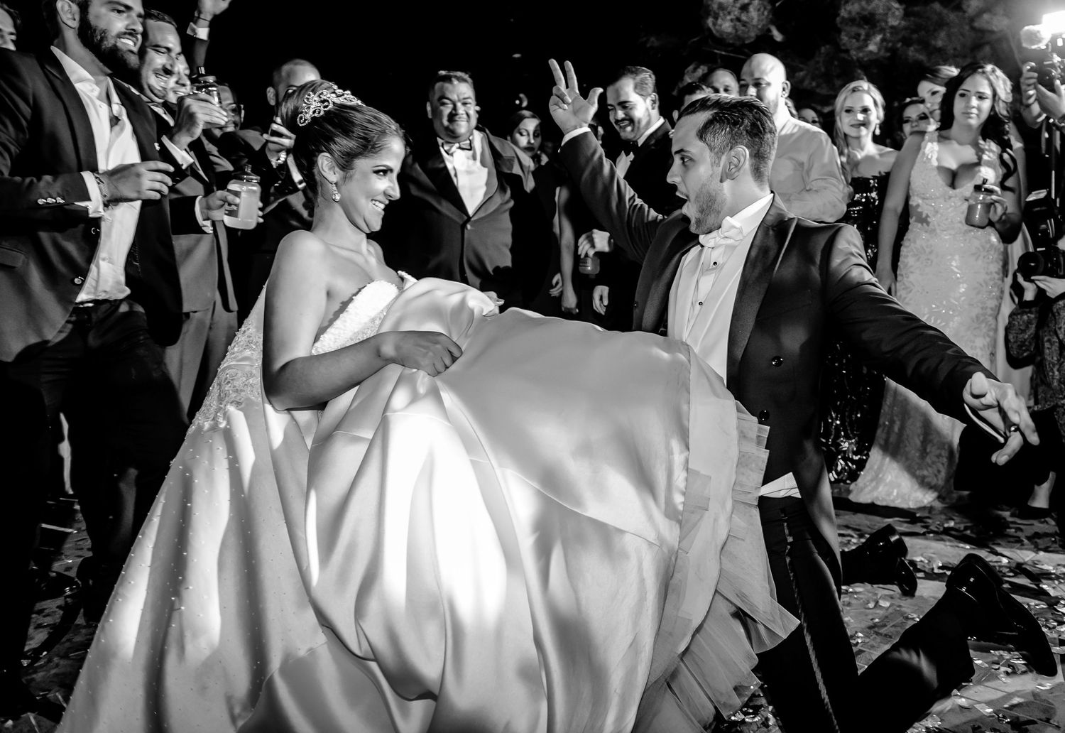 Wedding party dancing and celebrating at a lively reception.