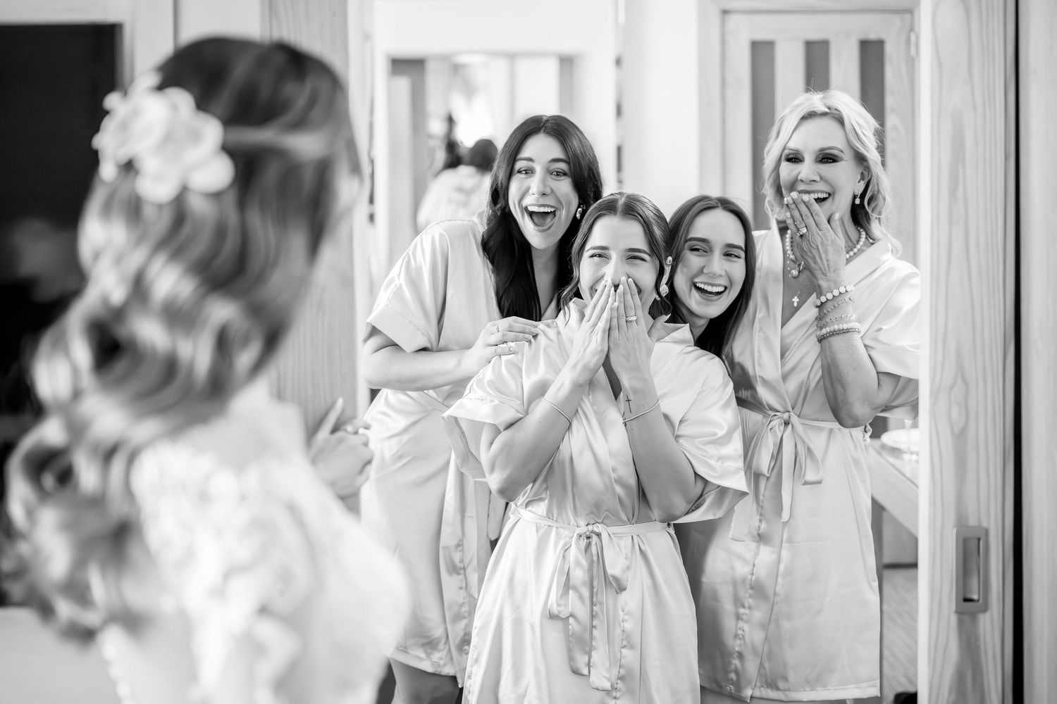 Black and white wedding photo collage showing candid moments of bridal party preparations.