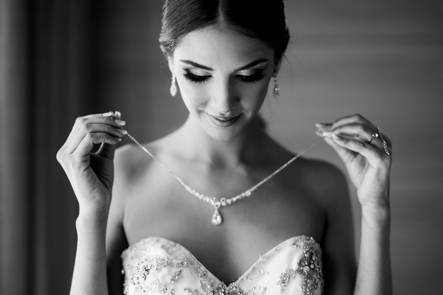 Series of black and white photos showing bride getting ready in lace dress.