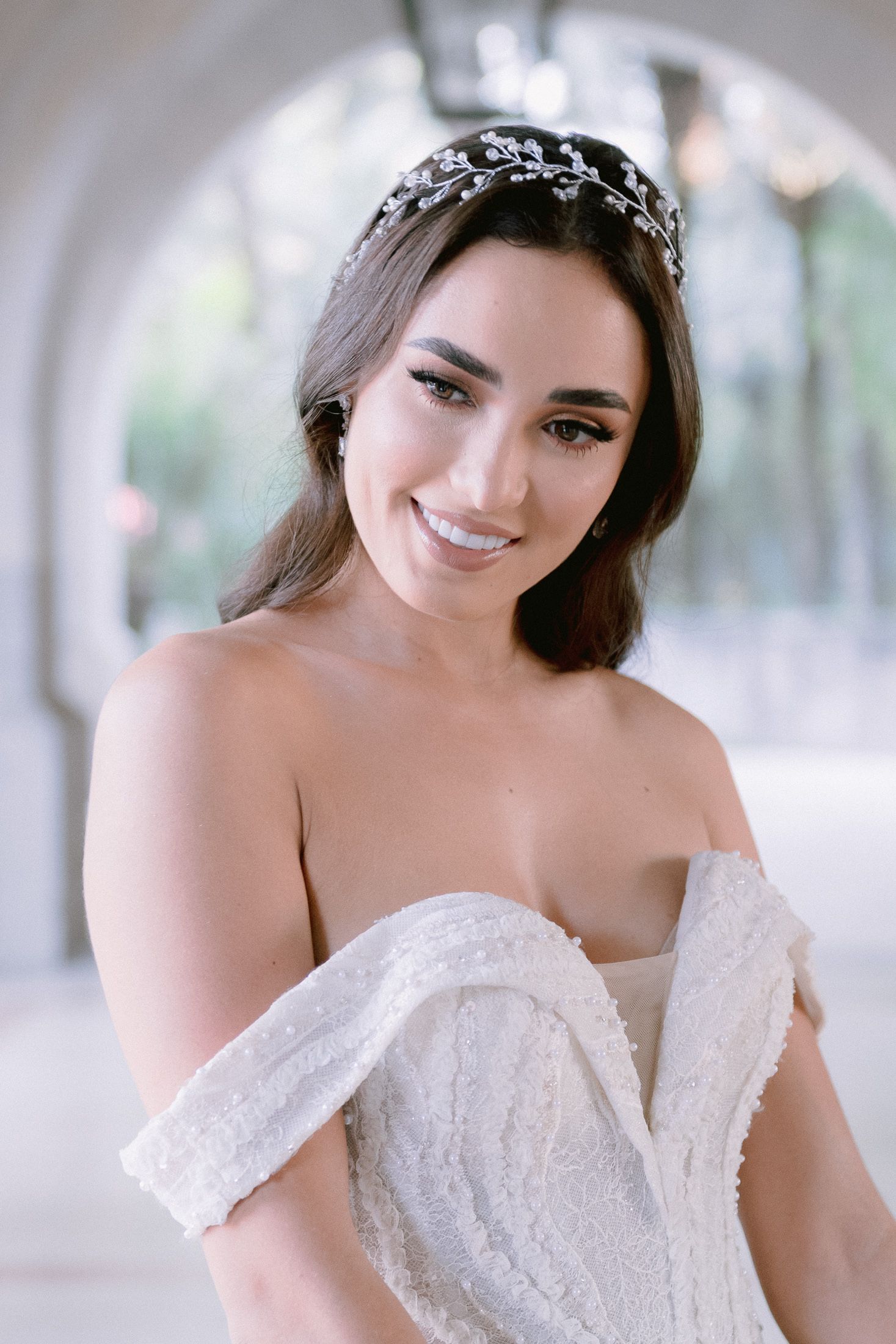 Romantic bridal portraits with soft lighting and an off-shoulder wedding dress.