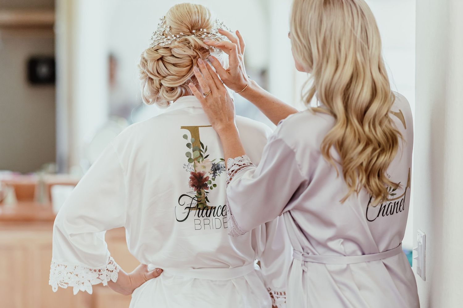 Series showing bridal party getting ready in matching robes with delicate lace details.