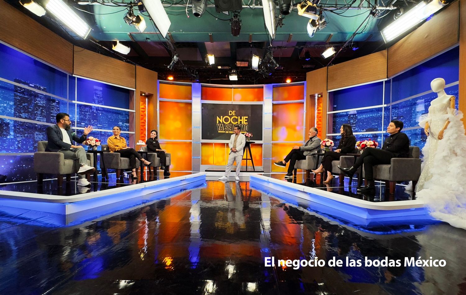 Professional broadcast studio setup with blue lighting and multiple camera angles for television production.