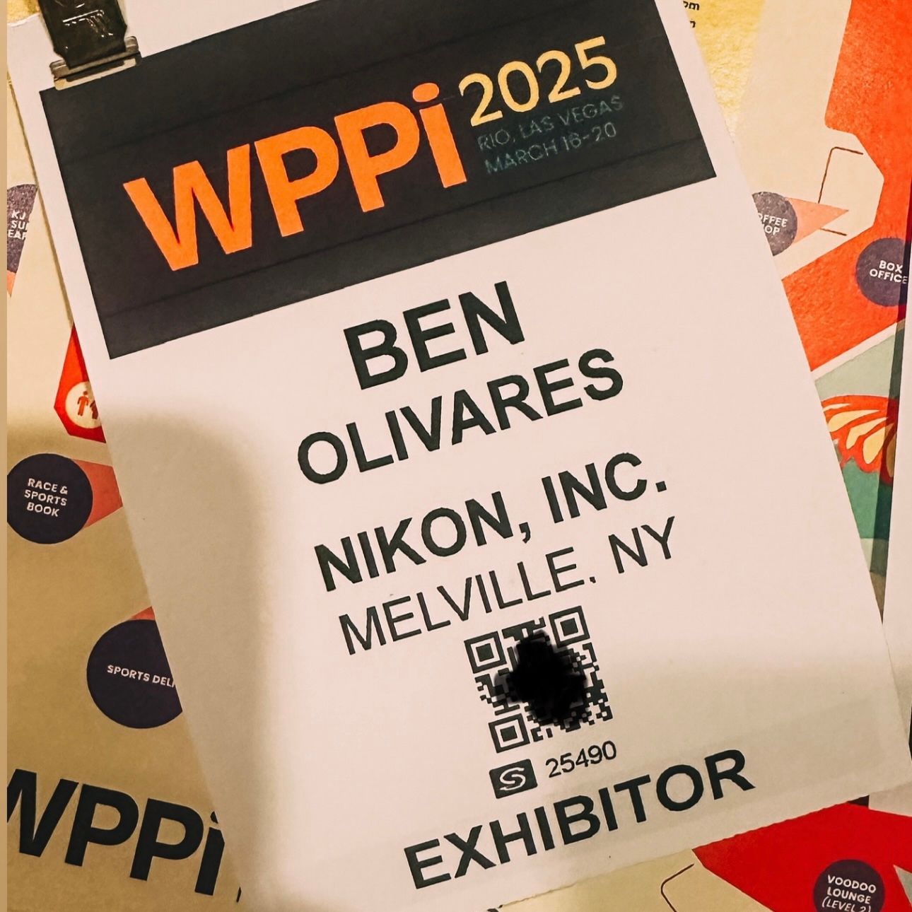 Collection of name badges and exhibitor passes from a photography event.
