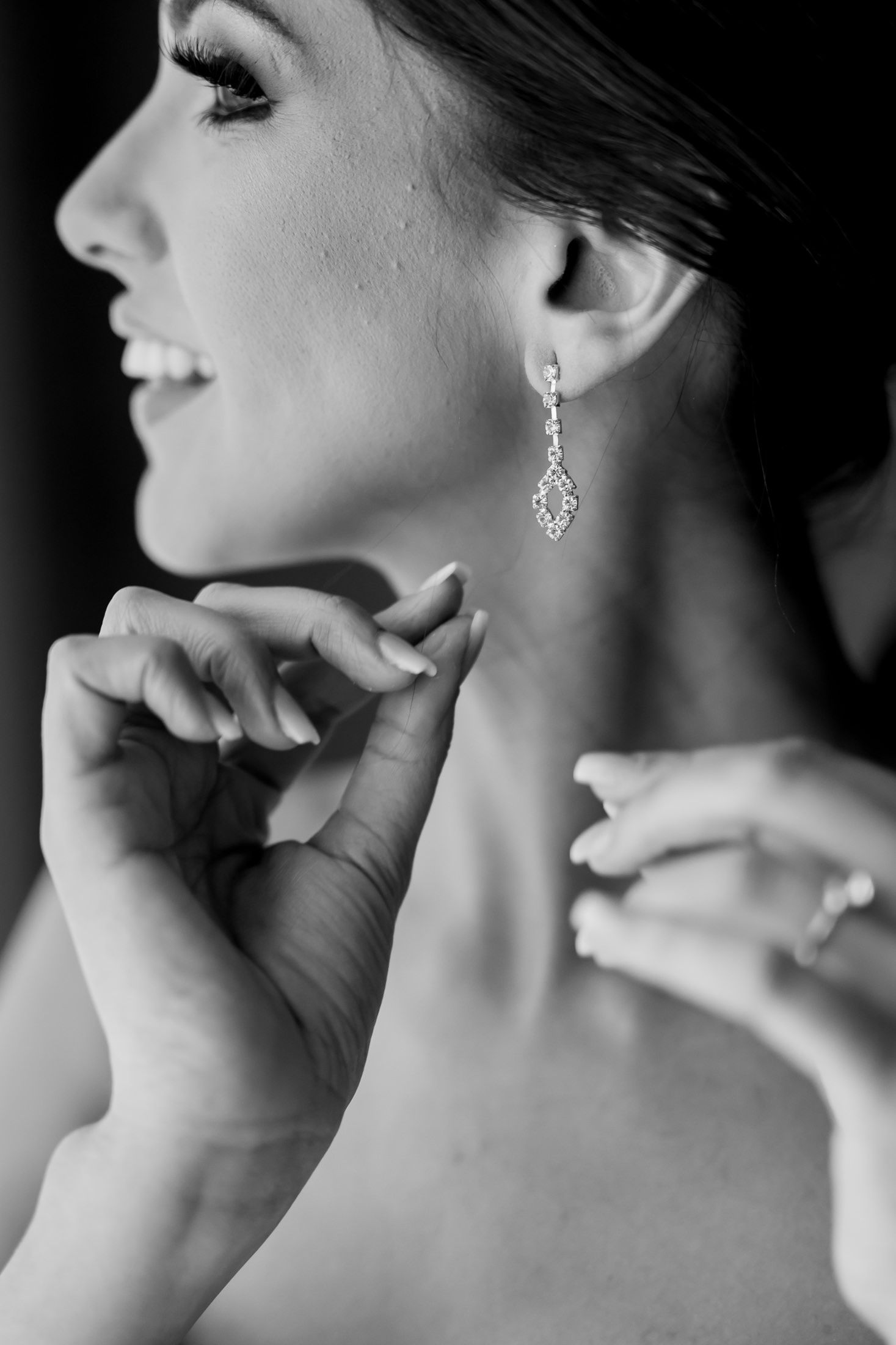 Black and white profile shots showing elegant diamond drop earrings.