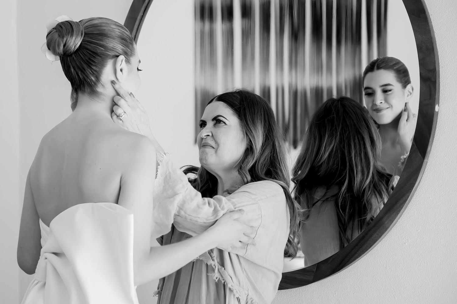 Wedding preparation scene showing emotional moments in black and white.