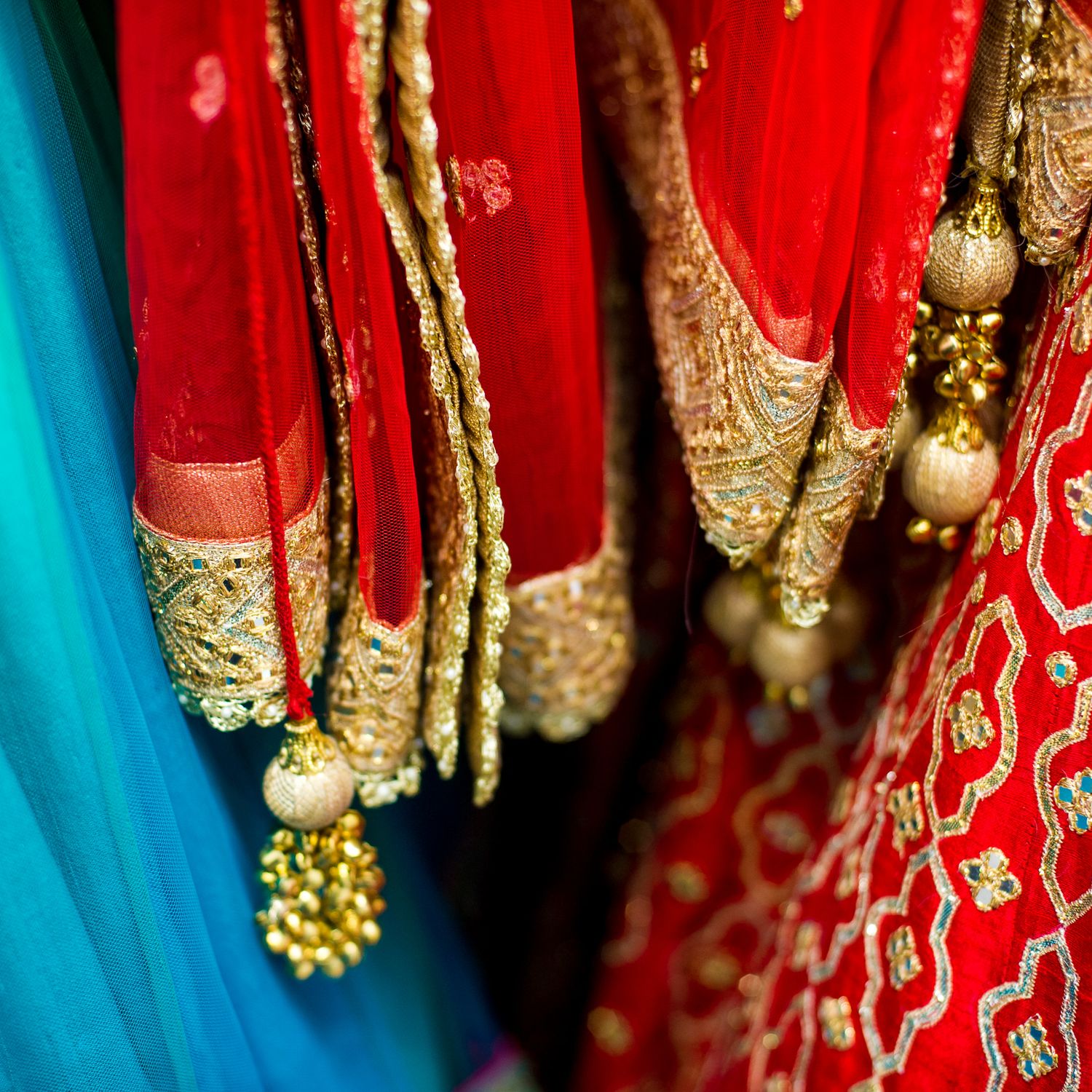 Close-up details of traditional Indian wedding jewelry with gold and red accents.