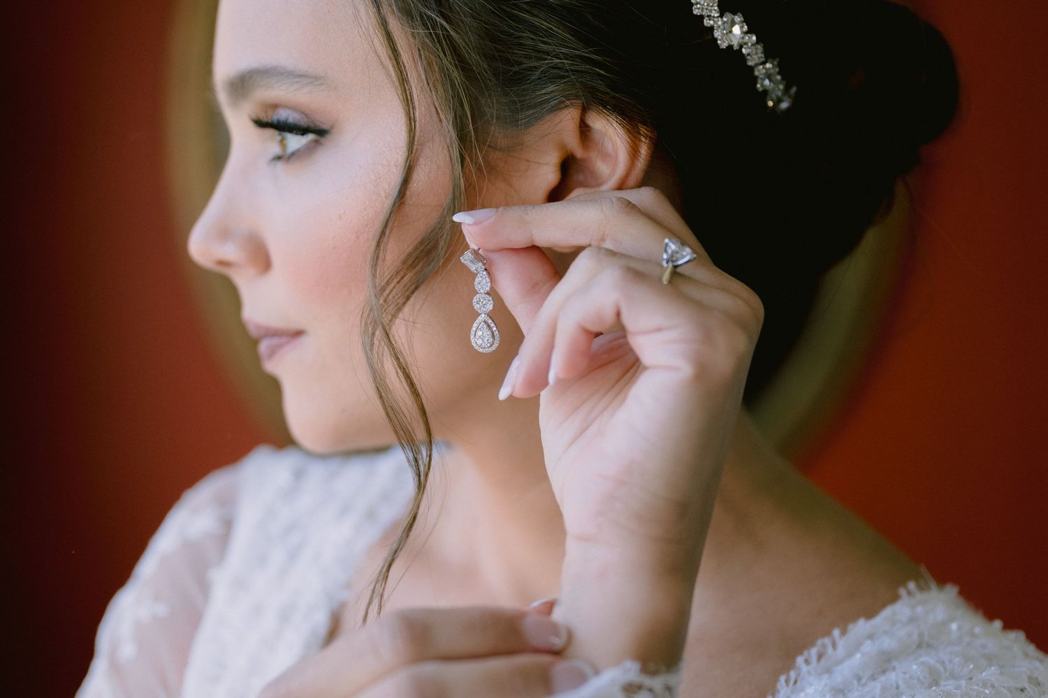 Side profile of bride wearing elegant earrings and updo hairstyle.
