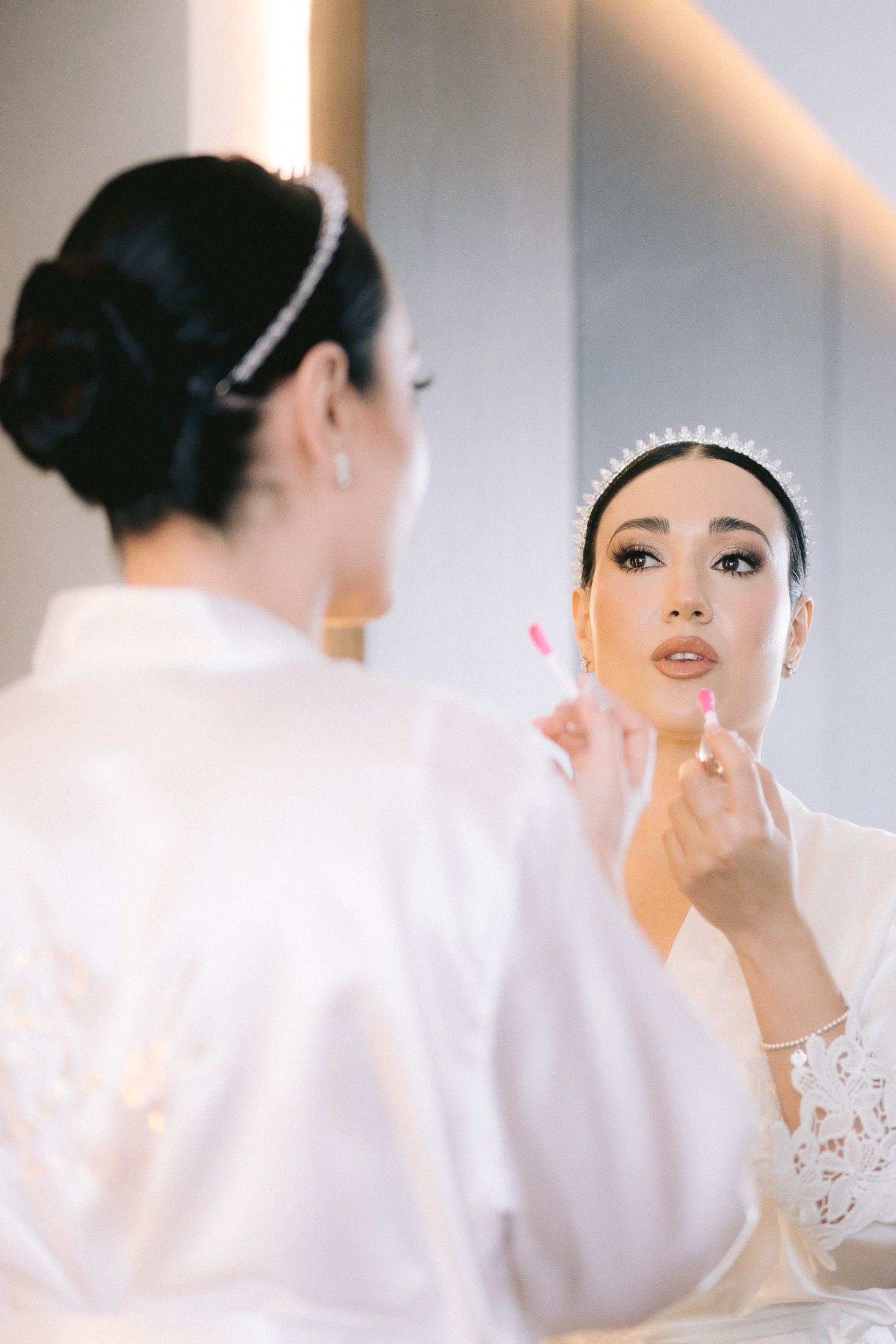 Close-up shots of a bride getting ready on her wedding day showing elegant makeup application and styling.