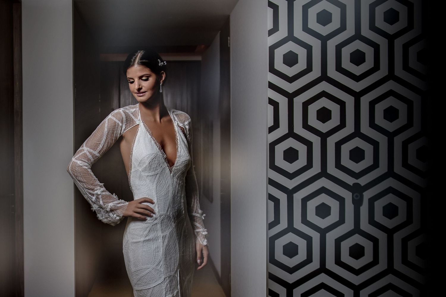 Modern interior wedding photography with geometric wallpaper patterns creating artistic compositions.