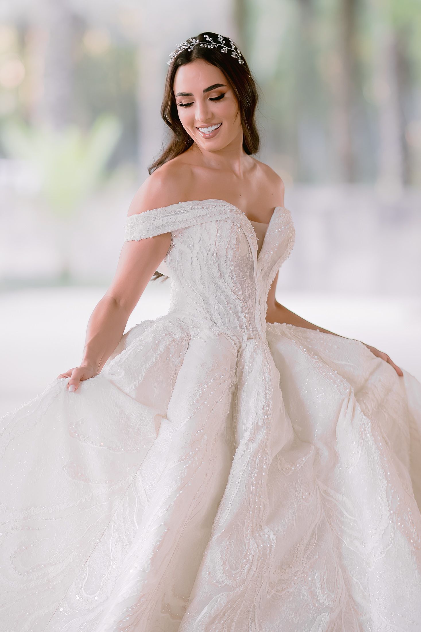 Romantic bridal portrait showcasing a luxurious white ball gown with intricate details.