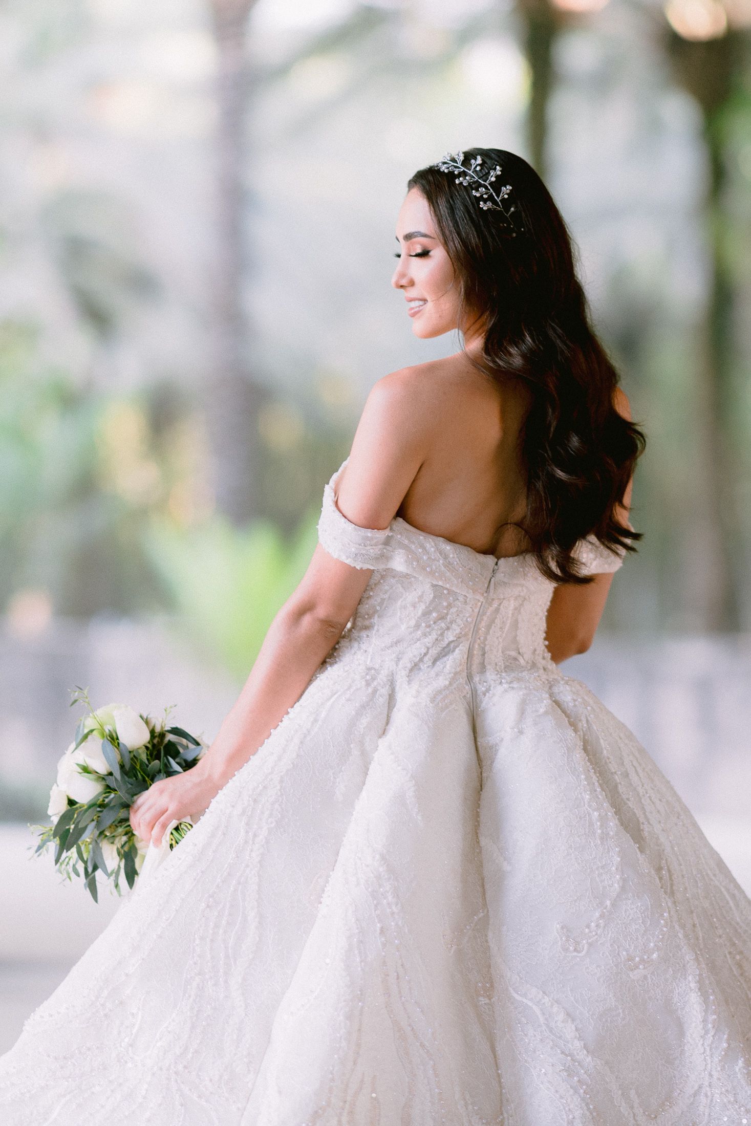 Graceful movement captured in flowing wedding dress with detailed bodice and full skirt.