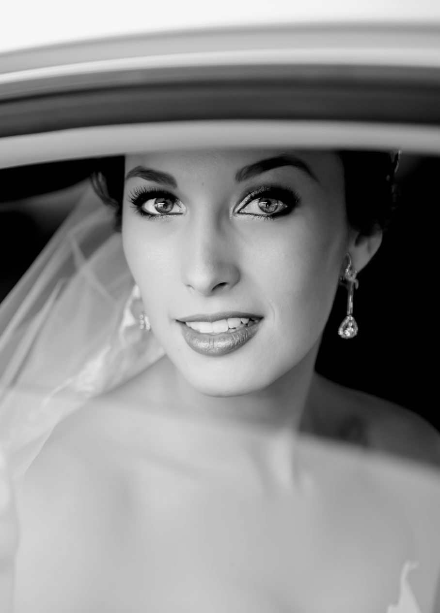 Classic black and white portrait with dramatic lighting and wide-brimmed hat.