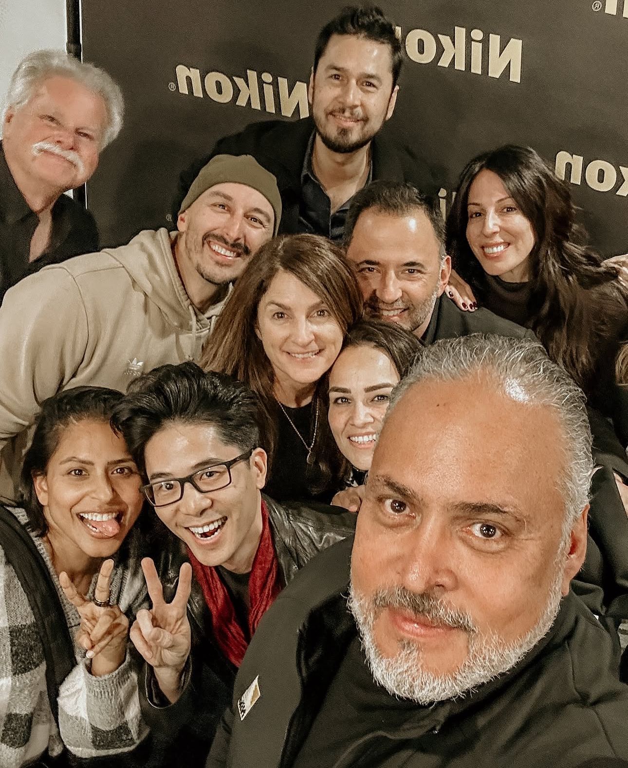 Selfie style group photo of attendees at a Nikon corporate gathering.