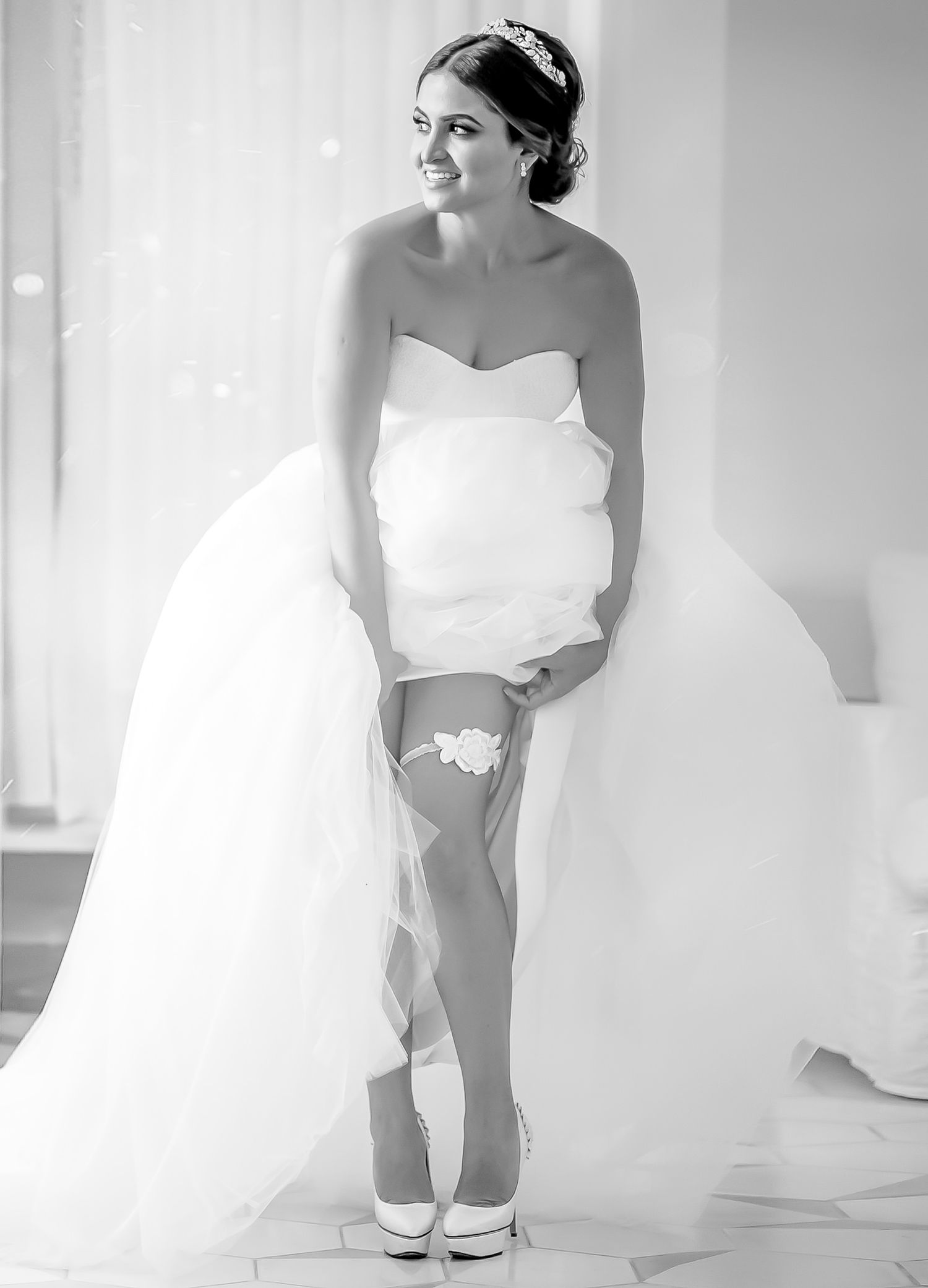 Ethereal black and white photos of a wedding dress being fitted.