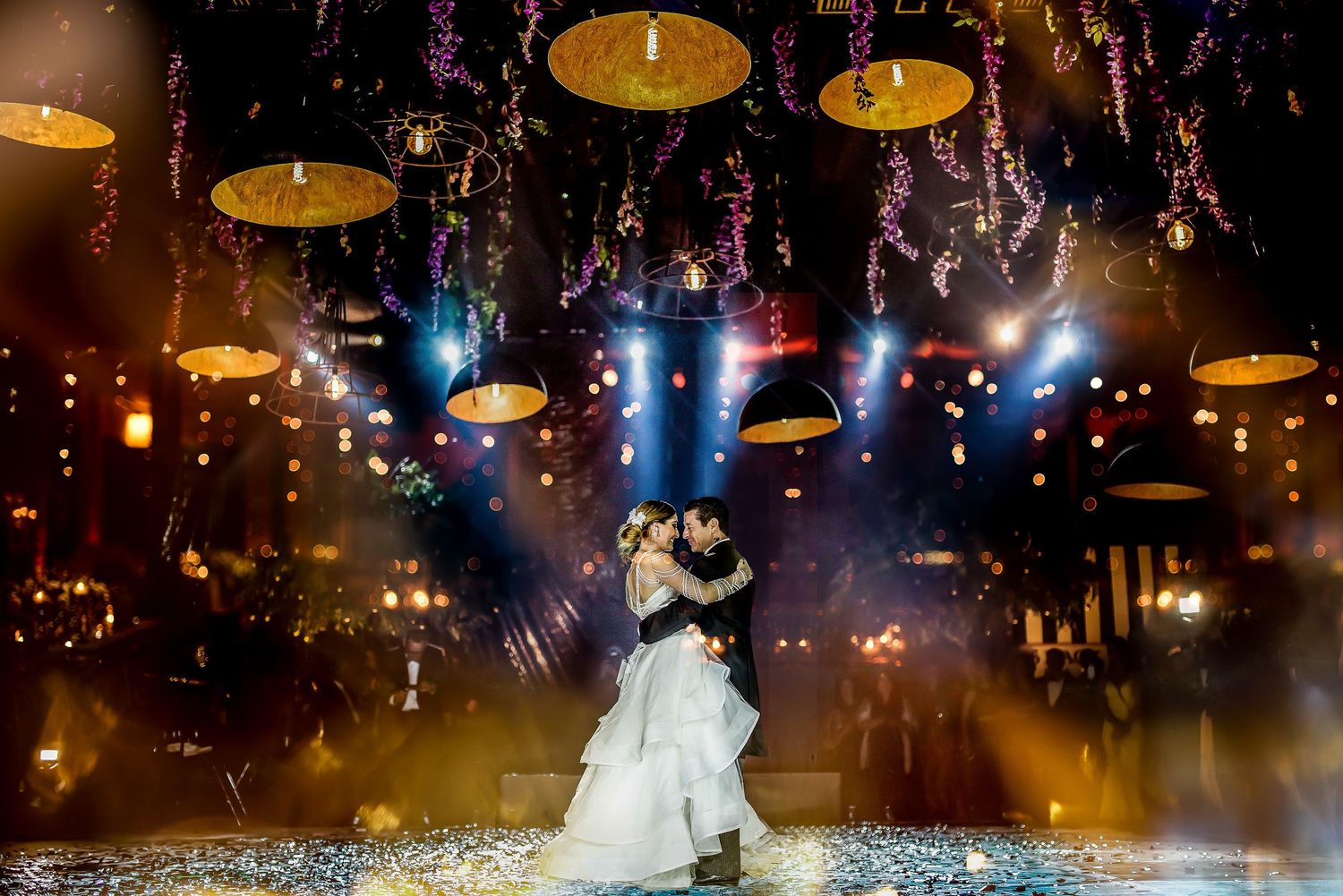 Wedding dance floor with hanging candles and crystal decorations creating an intimate ambiance.