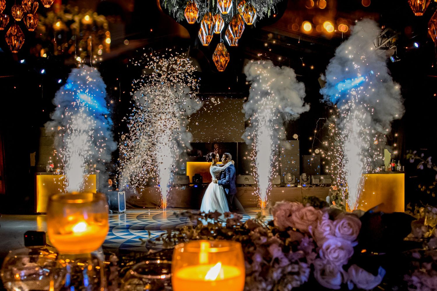 Wedding celebration with dramatic sparkler effects and ambient lighting creating a festive atmosphere.