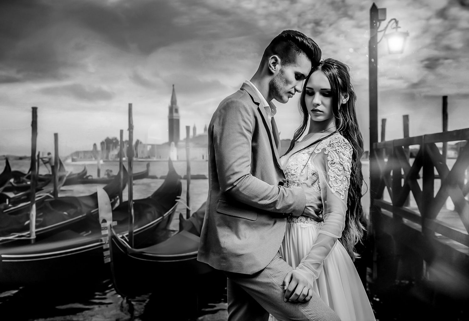 Romantic couple silhouettes against dramatic sunset with Venice gondolas in background.