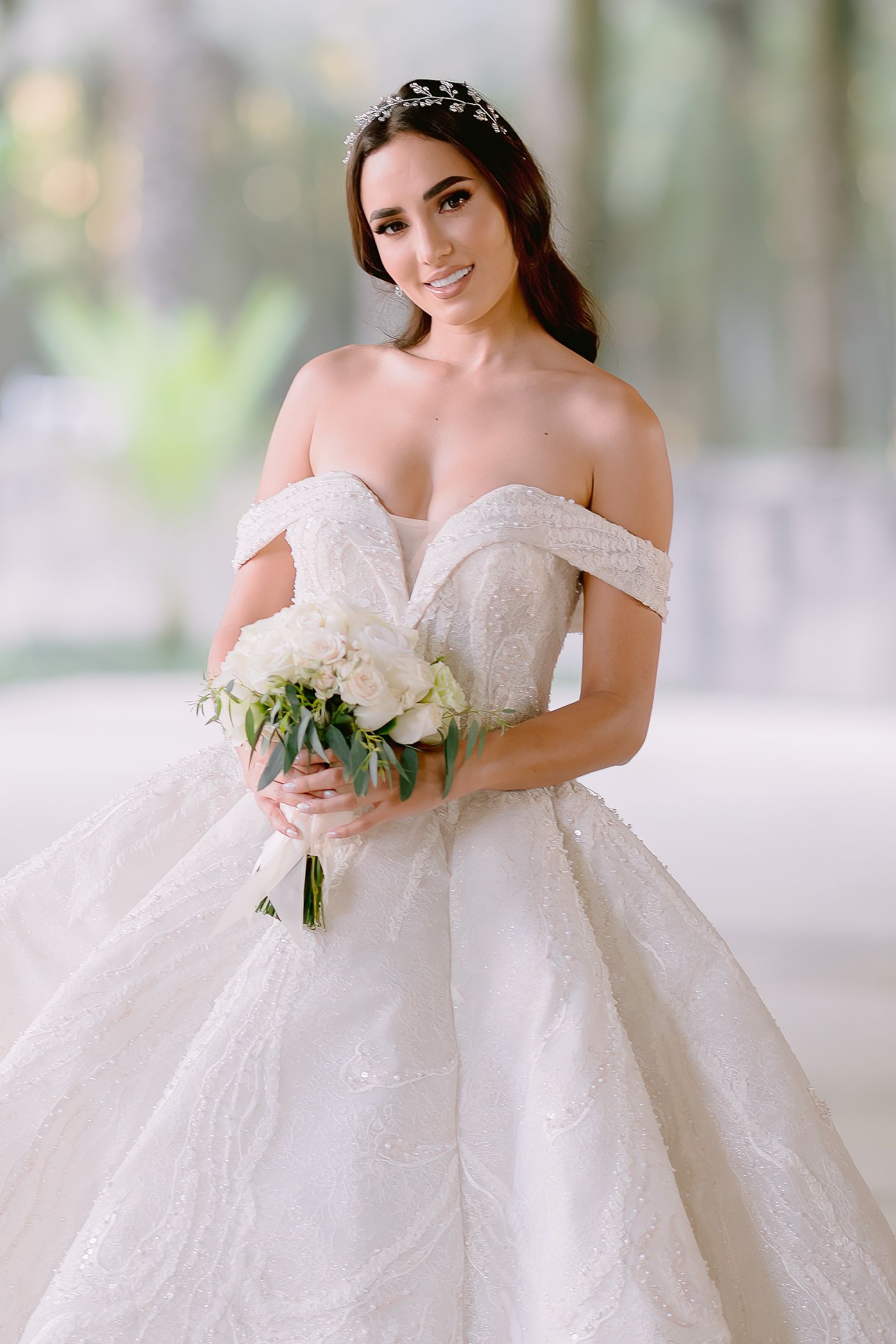 Elegant off-shoulder ballgown wedding dress with lace details and full skirt.