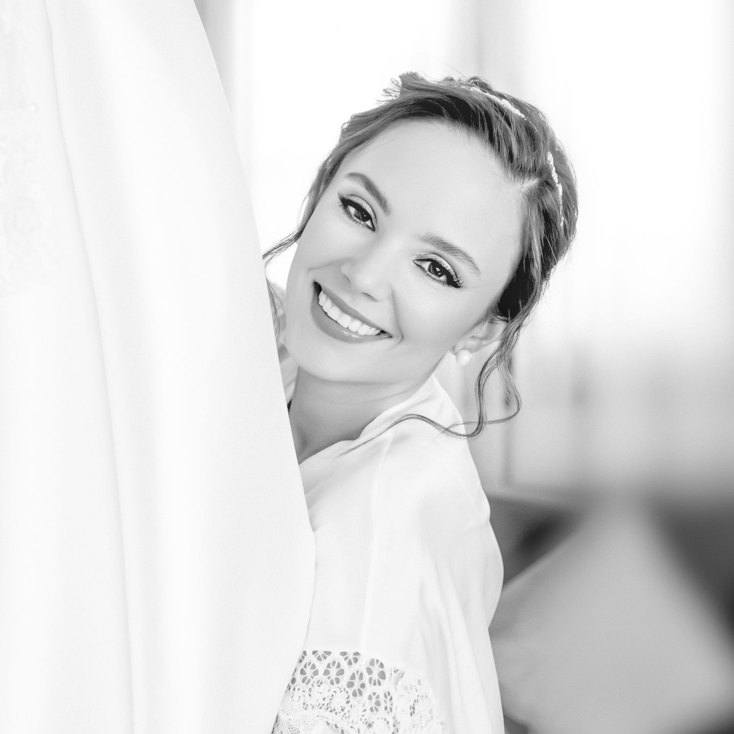 Black and white portraits showing wedding day preparation moments.