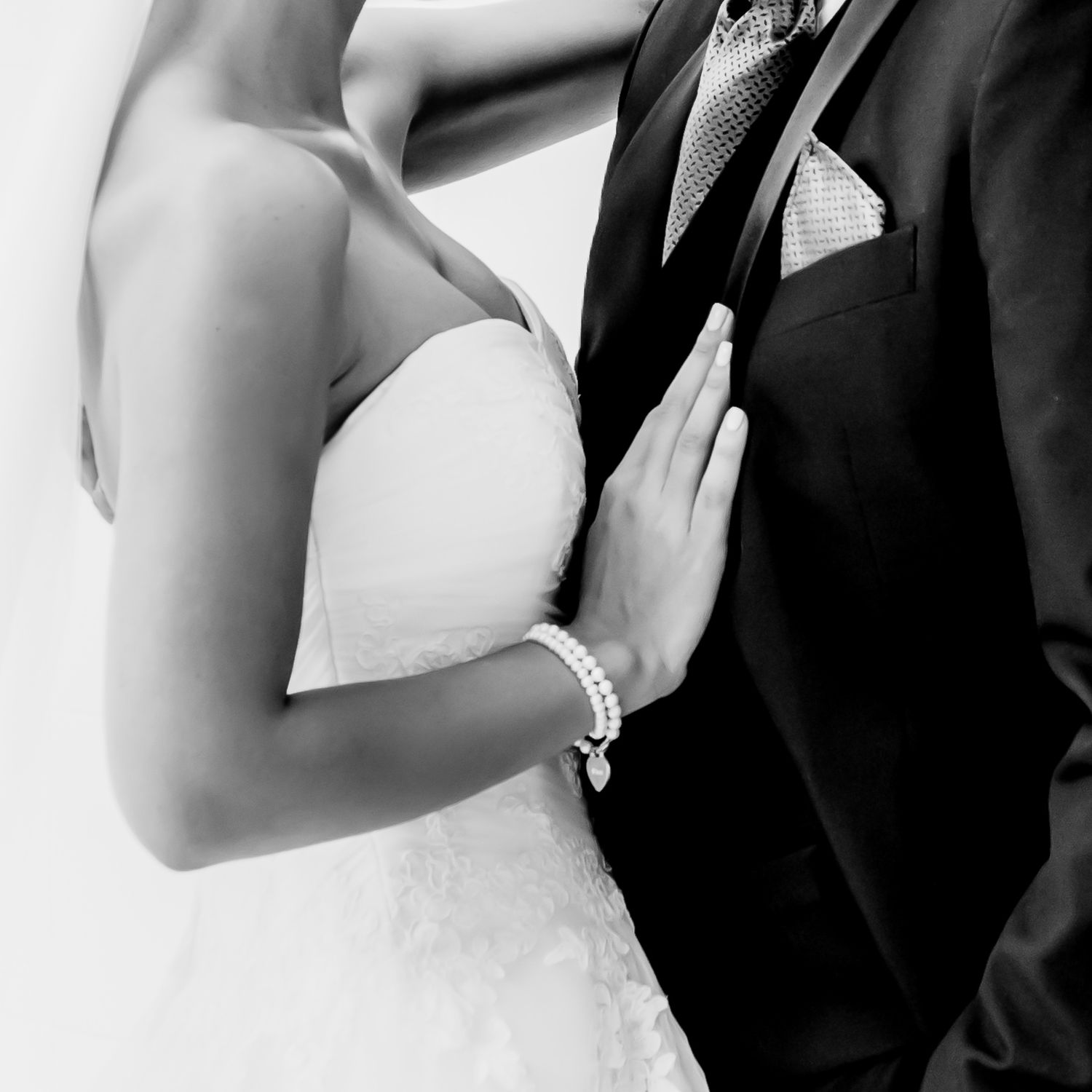 Elegant black and white composition showing bride and groom during ceremony.
