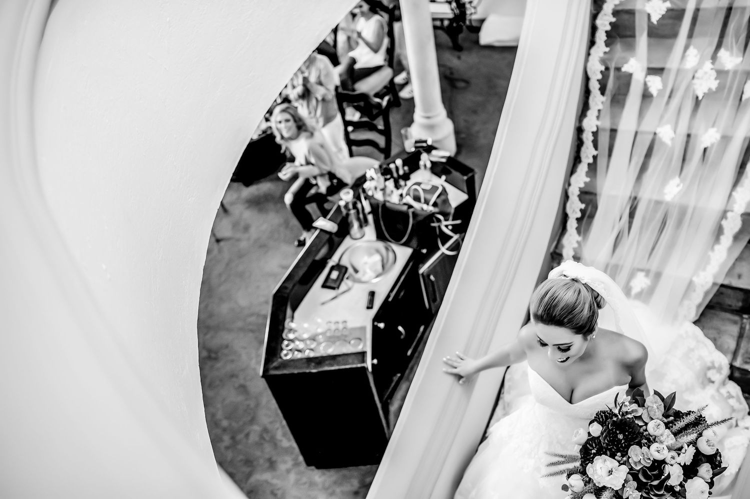 Elegant black and white wedding ceremony details with floral arrangements.