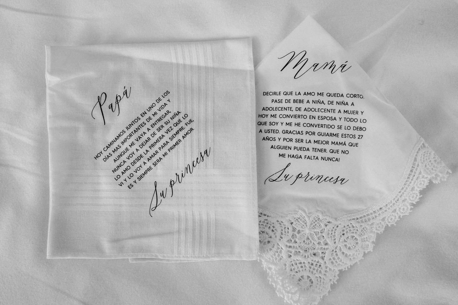 Two personalized embroidered wedding handkerchiefs with heartfelt messages for the bride's parents, labeled Papa and Mama.
