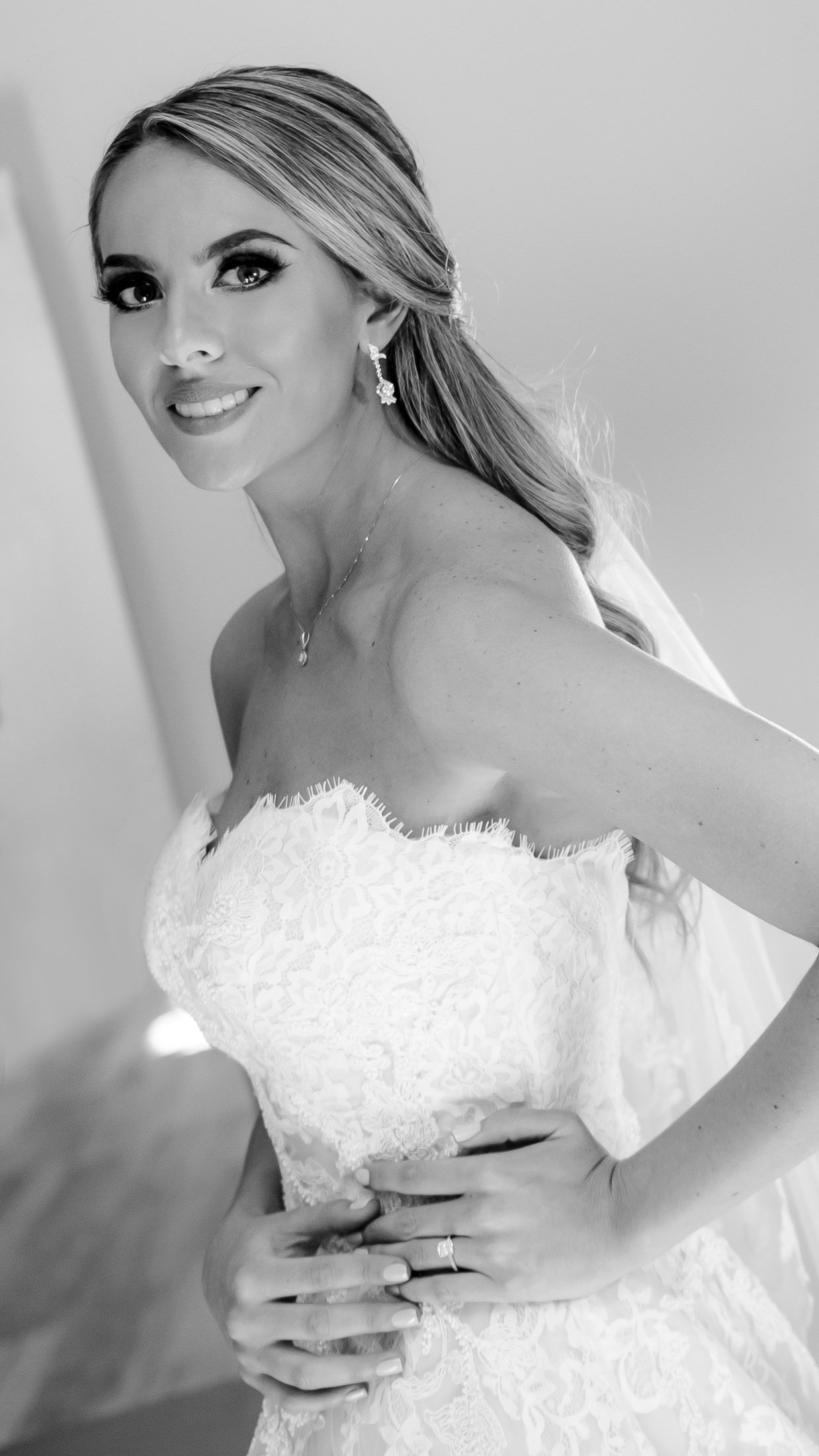 Close-up wedding preparation shots showing delicate lace details of a white bridal gown.