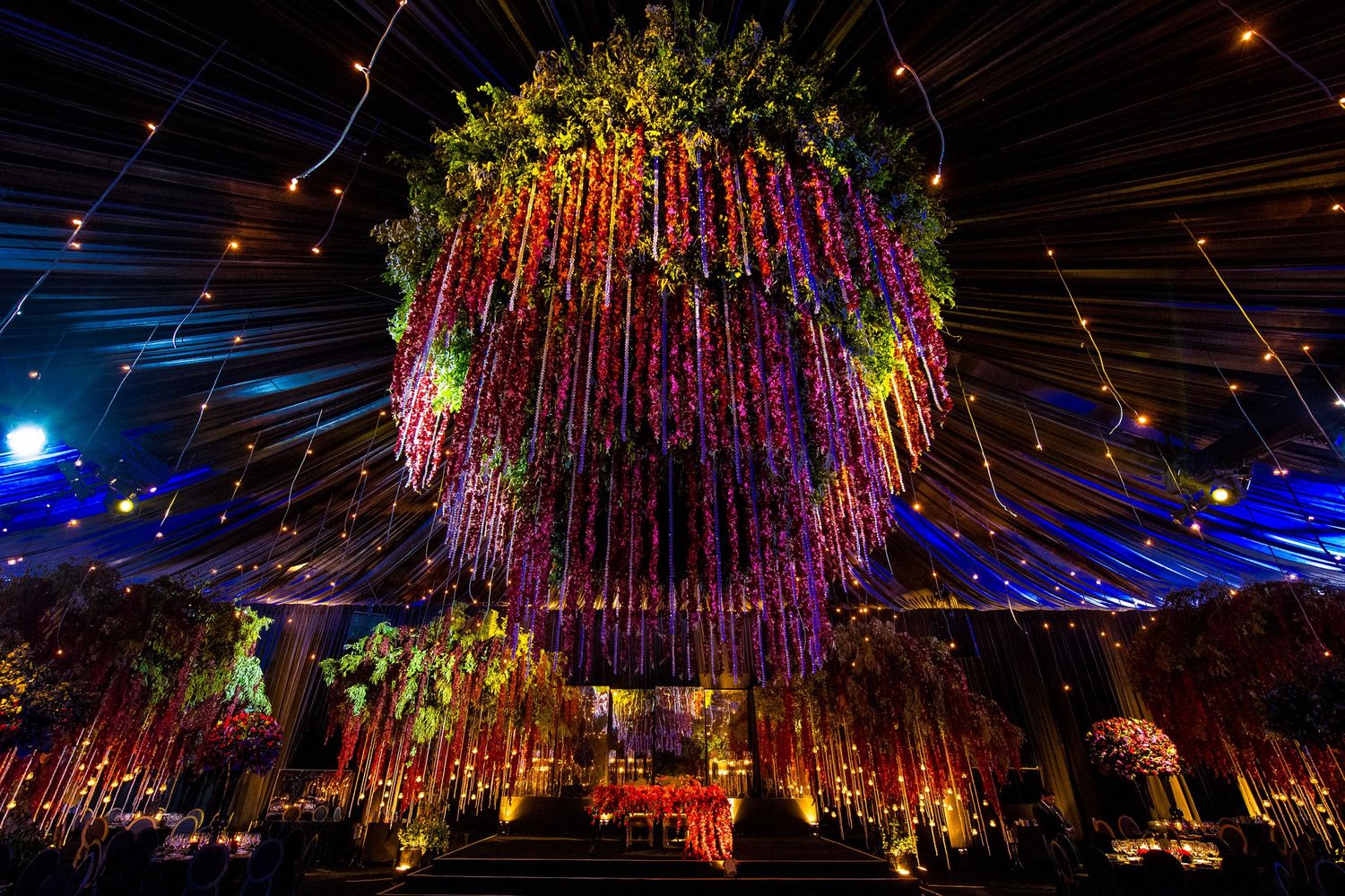 Spectacular overhead light installation with cascading colorful strands creating a magical canopy.