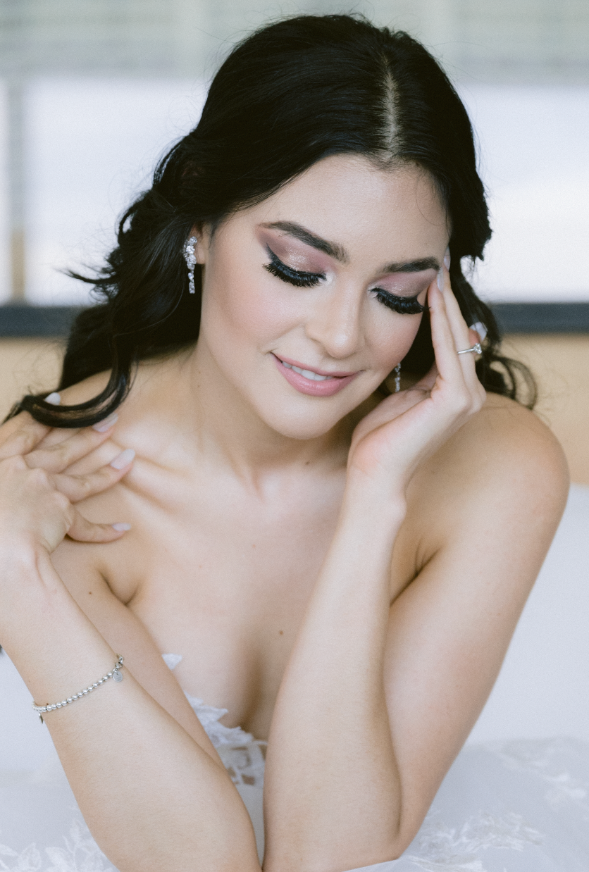 Romantic bridal photo with soft lighting and delicate white lace details.