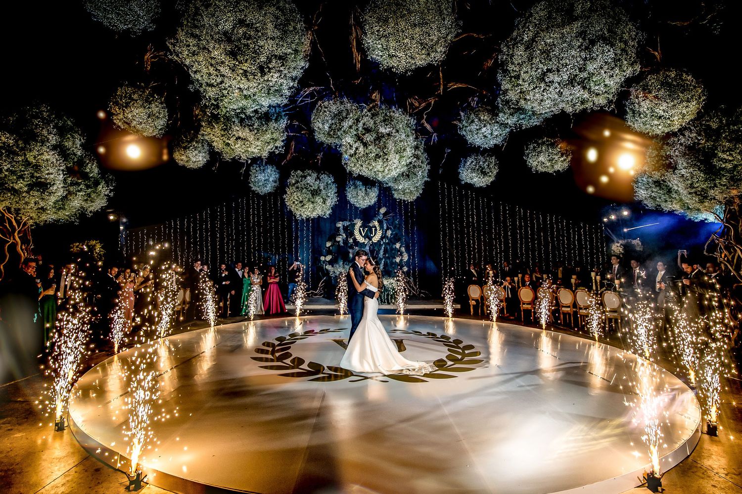 Wedding celebration with dramatic sparkler effects and floral decorations creating a magical finale.
