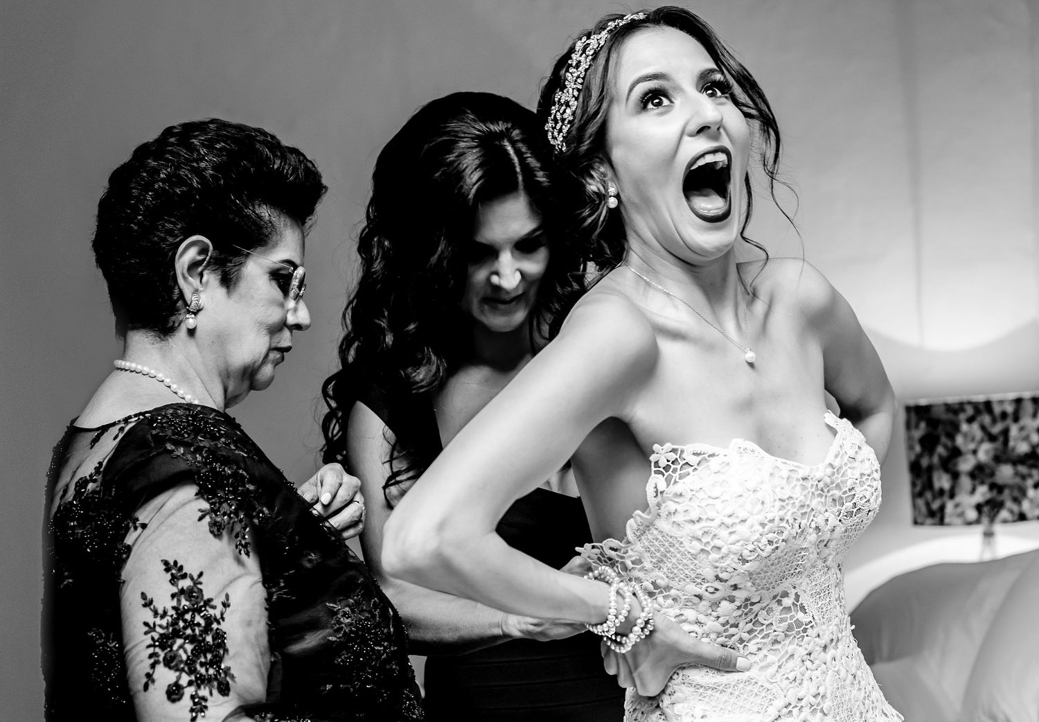 Wedding party enjoying candid laughter and joyful moments during celebration.