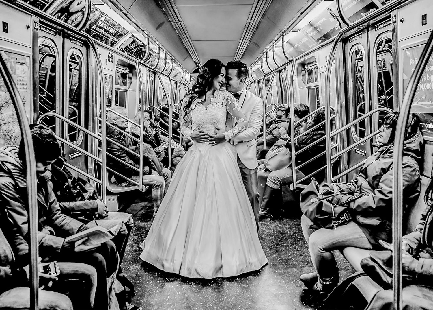 Black and white panoramic view of subway car interior with passengers and curved ceiling.