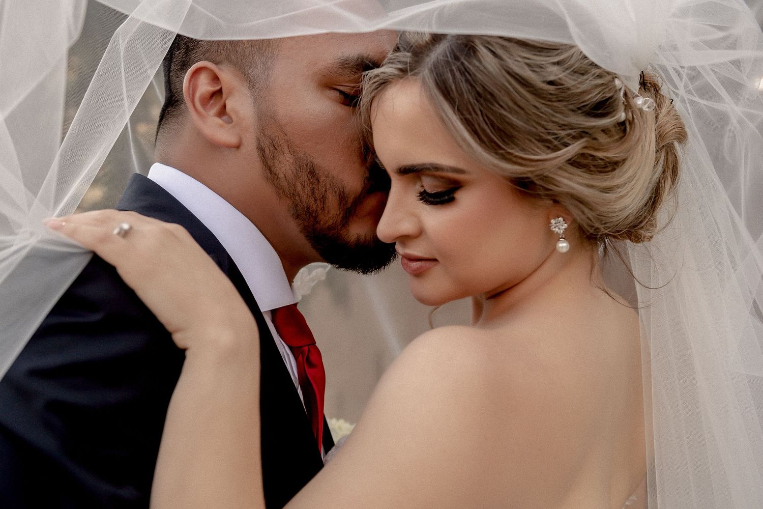 Close-up wedding photography showing delicate details of bridal veil and jewelry.